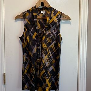 NWT geometric pattern, sleeveless blouse. Tie neck. Satiny type fabric.